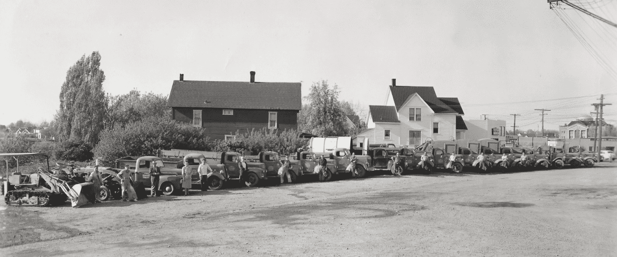 Queue of garbage trucks parked in front of a house