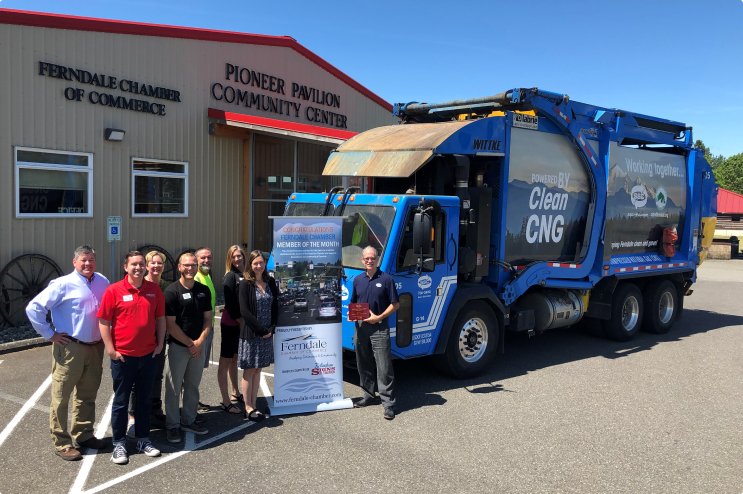 People standing near garbage truck around Ferndale Chamber of Commerce